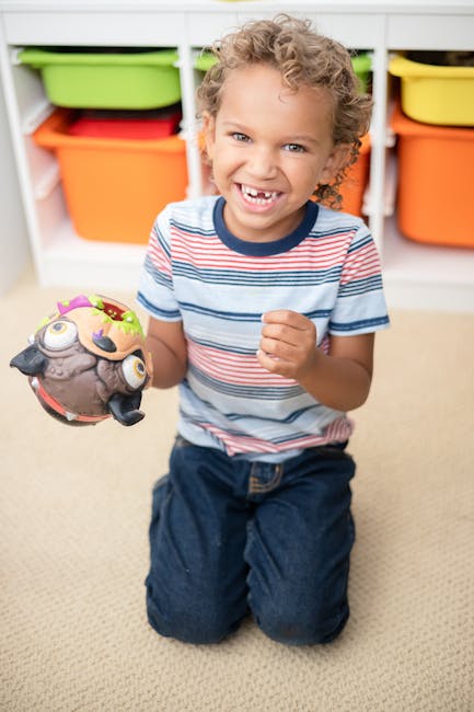 A joyful young boy enjoying playtime with colorful toys in a home setting.